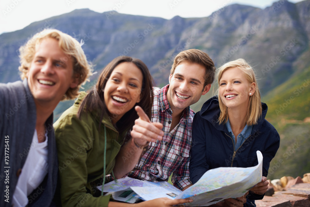 Obraz premium Happy people, friends and pointing with map for travel, location or destination on mountain in nature. Young group with smile, document or geographic paper for navigation, help or outdoor tourism