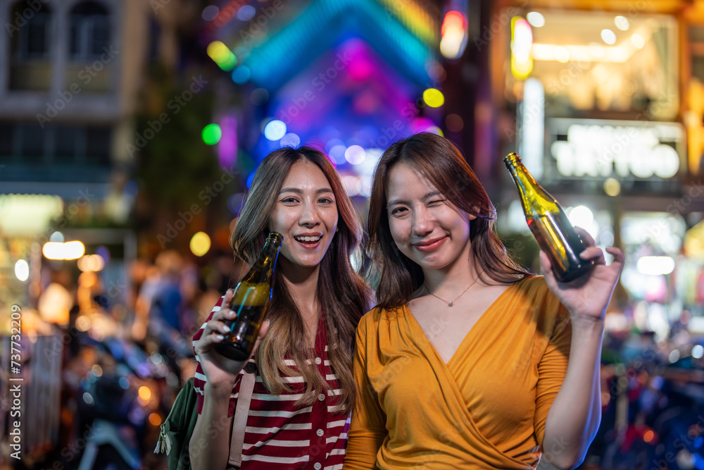 Portrait of Asian woman friends drink beer, having party infront of bar. Portrait of Asian woman friends drink beer, having party infront of bar.