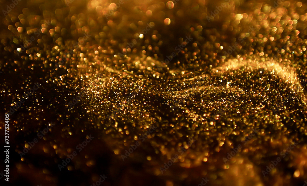 Gold light shine particles on black background. Glitter lights grunge background, gold glitter defocused abstract Twinkly Lights Background. Can used wallpaper or pattern.