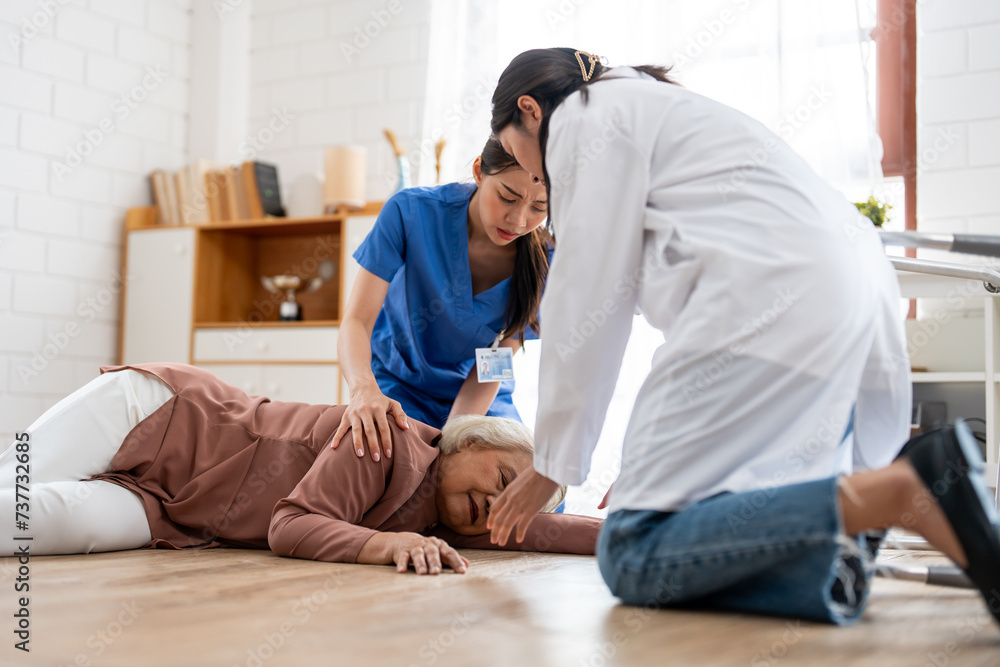 Asian caregiver help senior female from falling on the ground at home. Asian caregiver help senior female from falling on the ground at home.