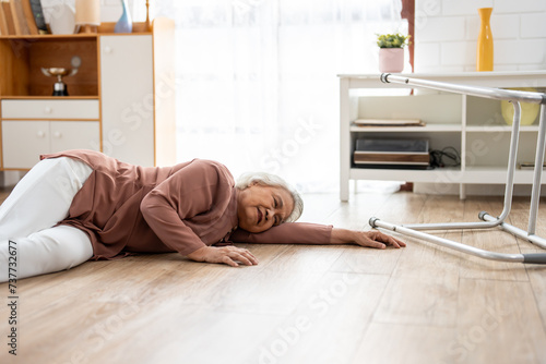 Asian senior elderly female fall on the ground while walk alone in house. 