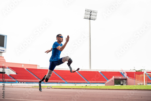 Asian para-athletes disabled with prosthetic blades running at stadium.  © Kawee