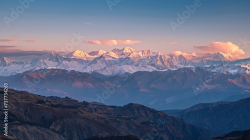Golden hour brilliance on snow-capped mountains, a breathtaking panorama