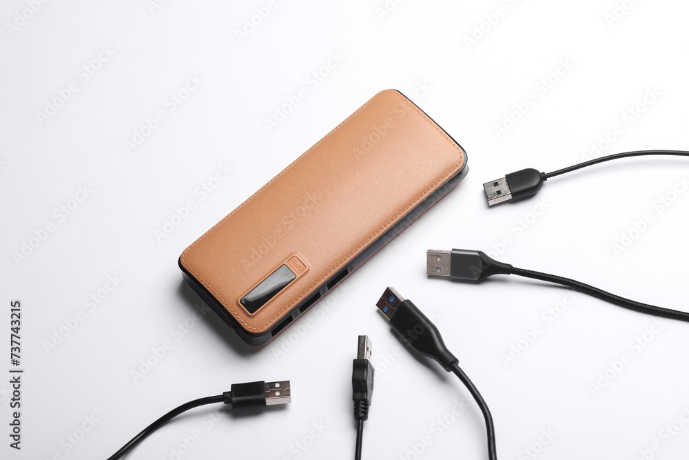 External battery power bank with many cables on a white background External battery power bank with many cables on a white background