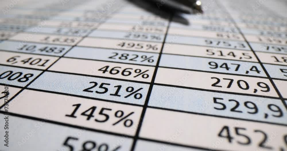 Sheet with different financial data and pen on clerk desk Sheet with different financial data and pen on clerk desk