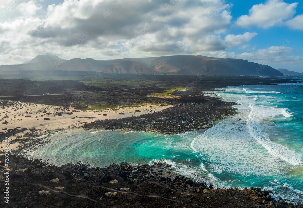 Landscape with turquoise ocean water on Caleta del Mojon Blanco in Lanzarote, Canary Islands, Spain