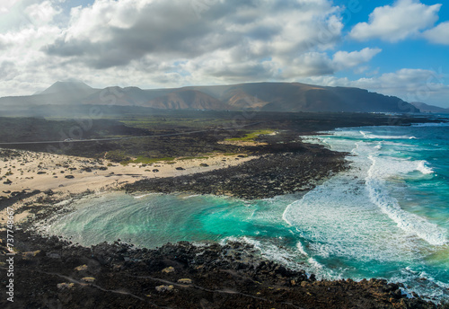 Landscape with turquoise ocean water on Caleta del Mojon Blanco in Lanzarote, Canary Islands, Spain