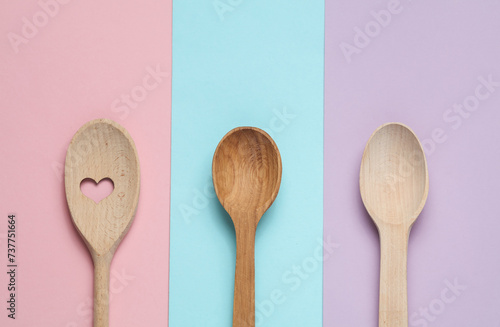 Natural wooden spoons on a colored background photo