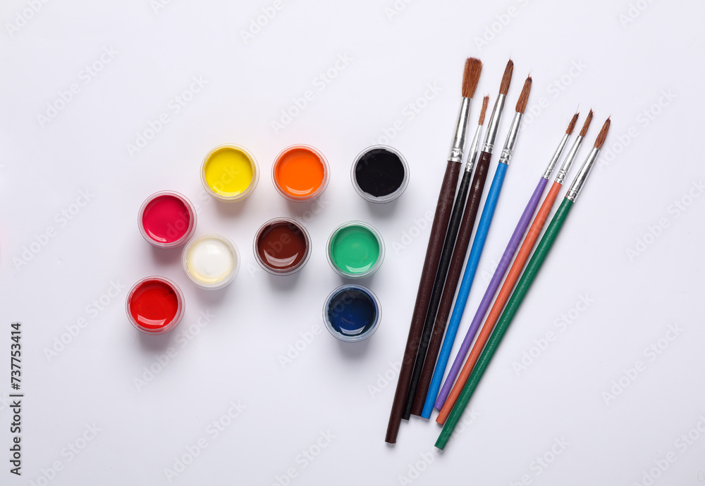 Set of gouache paints in bottles with brushes on a white background. Children's creativity Set of gouache paints in bottles with brushes on a white background. Children's creativity