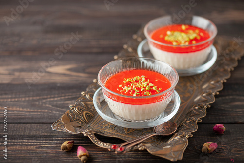 Malabi (muhallebi) milk rice pudding with pistachios. Arabic dessert photo