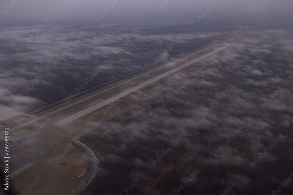 Airport of Frankfur, one of the landing strips viewed from the air. Some clouds are gathering around. Airport of Frankfur, one of the landing strips viewed from the air. Some clouds are gathering around.
