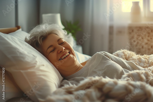 Elderly Woman Smiling in Dreamy Bed with Sunrays photo