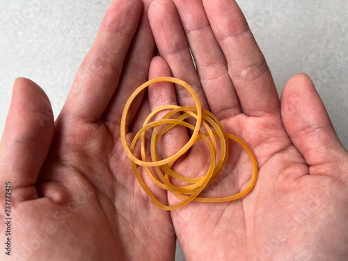 Red rubber band in hand. Elastic bands on hands. Karet gelang kuning. photo