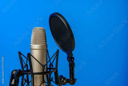 Professional microphone stand over blue studio background