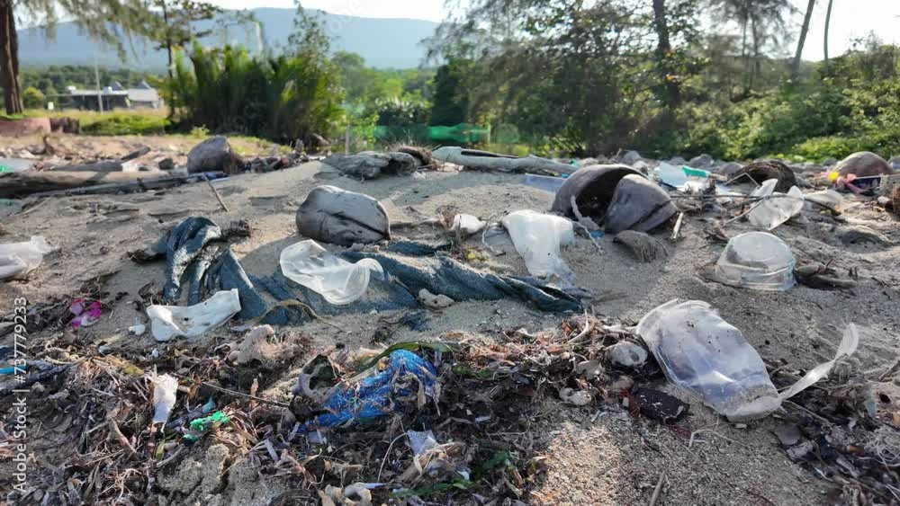 Plastic pollution on a sandy beach with mountains in the background, highlighting environmental issues for Earth Day awareness campaigns Plastic pollution on a sandy beach with mountains in the background, highlighting environmental issues for Earth Day awareness campaigns