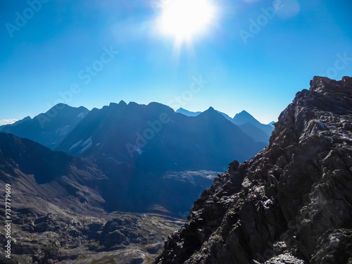 Unique rock formations with panoramic view of the majestic mountain ridges of High Tauern seen near Gloedis in Schober group, East Tyrol, Austria, EU. Idyllic high alpine landscape in Austrian Alps photo