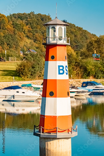 Summer view with reflections, pleasure boats and a lightouse at Vilshofen, Danube, Bavaria, Germany photo