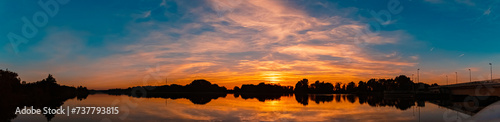High resolution stitched summer sunset panorama with reflections near Plattling  Isar  Bavaria  Germany