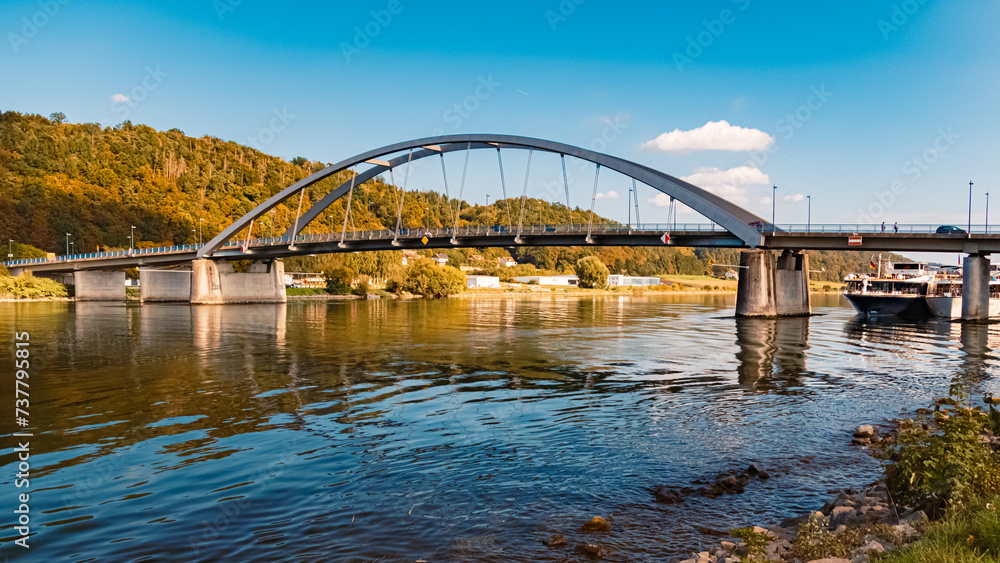 Obraz premium Summer view with reflections and a bridge at Vilshofen, Danube, Bavaria, Germany