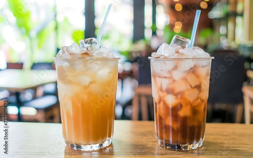 Two glass soft drink with ice in restaurant background