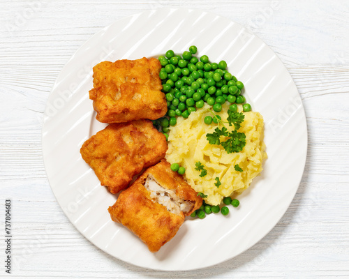 fried fish with mashed potatoes and green peas