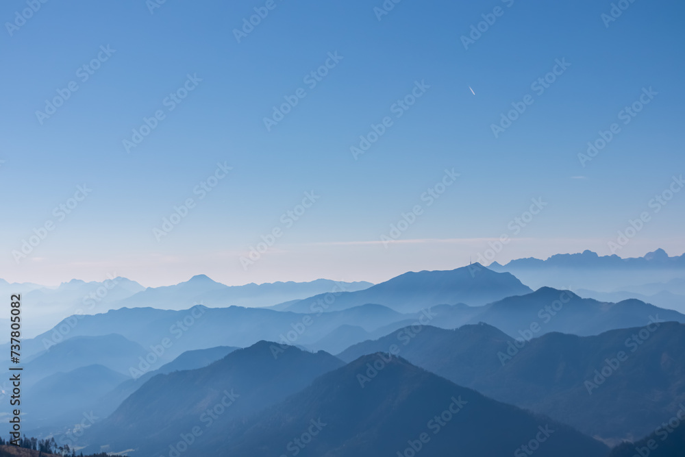 Obraz premium Panoramic view of magical mountain peaks of Karawanks and Julian Alps seen from Goldeck, Latschur group, Gailtal Alps, Carinthia, Austria, EU. Mystical atmosphere in Austrian Alps on sunny summer day.