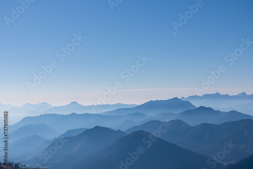 Panoramic view of magical mountain peaks of Karawanks and Julian Alps seen from Goldeck, Latschur group, Gailtal Alps, Carinthia, Austria, EU. Mystical atmosphere in Austrian Alps on sunny summer day.