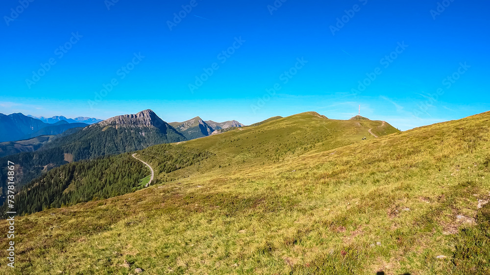 Panoramic view of rugged mountain peak Staff seen from Goldeck, Latschur group, Gailtal Alps, Carintha, Austria. High alpine road in Austrian Alps. Unique ridge surrounded by alpine forest