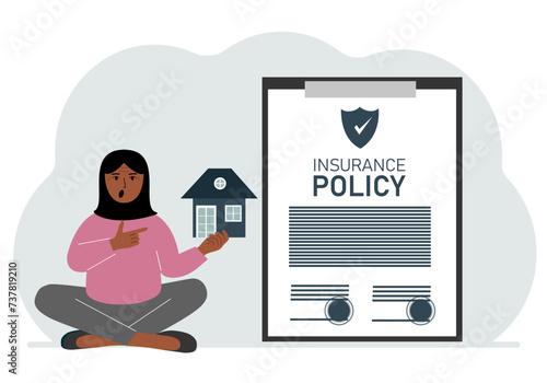 A woman holds in his hands at home next to a large insurance contract. Home and real estate insurance concept.