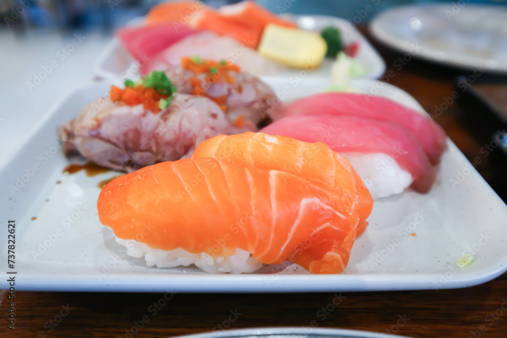 salmon sushi or rice topped with salmon , tuna sushi and beef sushi salmon sushi or rice topped with salmon , tuna sushi and beef sushi