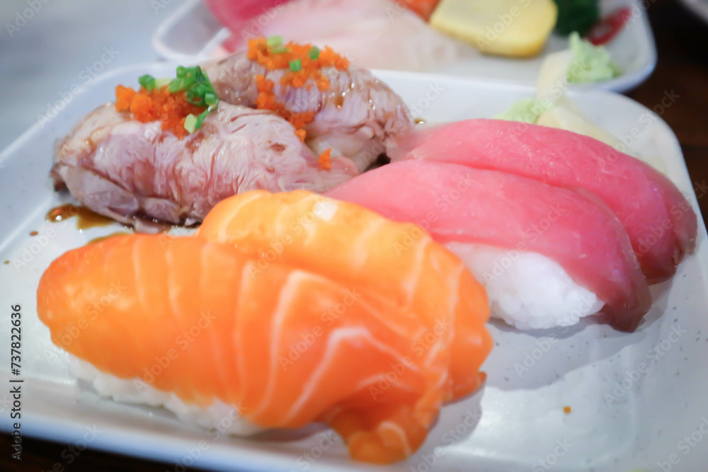 salmon sushi or rice topped with salmon , tuna sushi and beef sushi salmon sushi or rice topped with salmon , tuna sushi and beef sushi