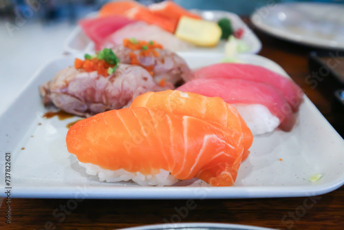 salmon sushi or rice topped with salmon , tuna sushi and beef sushi