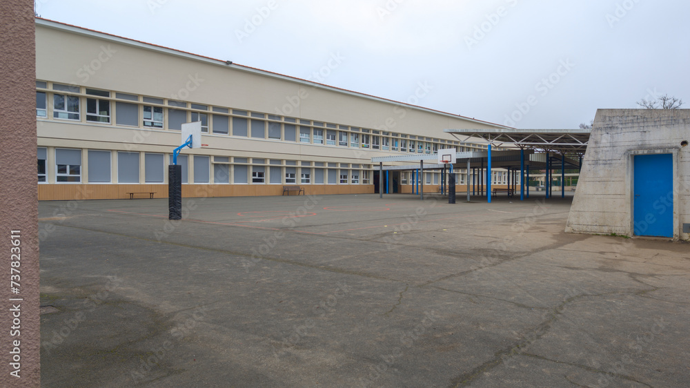 School building exterior primary schoolyard with basketball court