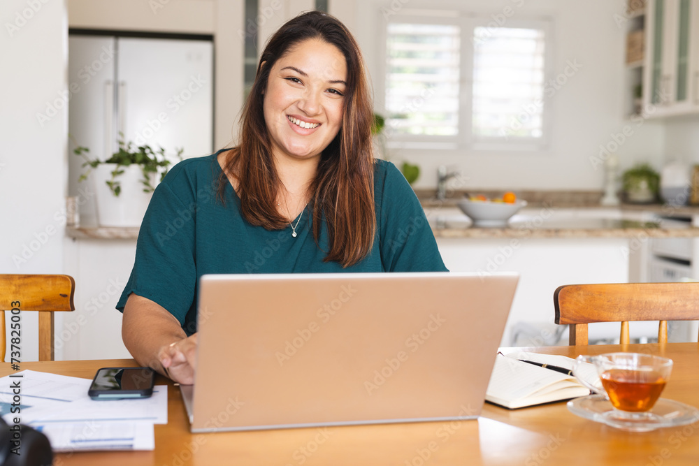 Young biracial woman works on her laptop at home Young biracial woman works on her laptop at home