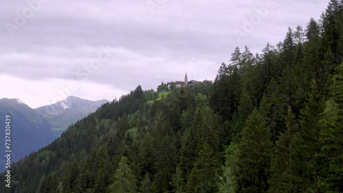 Zooming in on the village of Platt-Plata on a cloudy day, Passeier valley, South Tyrol, Italy photo