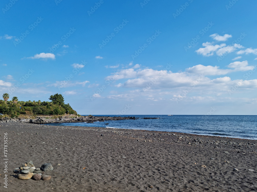 It is a beach with black sand.
It is a beach with black sand.