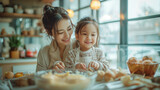 smilling mom and child enjoy love relation cudding hobby moment in kitchen sunday morning at hime mother and daughter helping prepare breakfast for her mom in modern white kitchen at home .