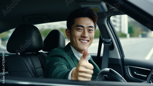 a man in a car giving a thumbs up