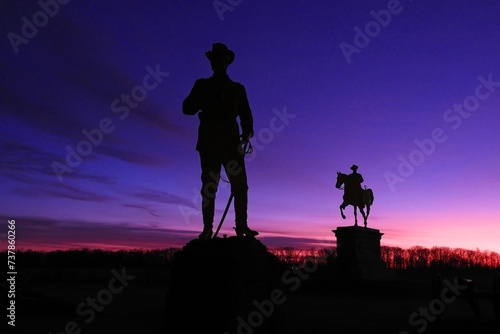  monument to general  john buford in of the equestrian monument of  general john fulton reynolds along chambersburg pike  in gettysburg national park, pennsylvania,  against a dramatic  winter sunrise photo
