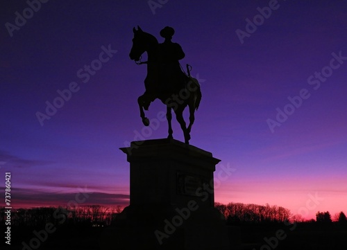  the equestrian monument of major general john fulton reynolds along chambersburg pike  in gettysburg national park, pennsylvania,  against a dramatic purple and pink winter sunrise photo