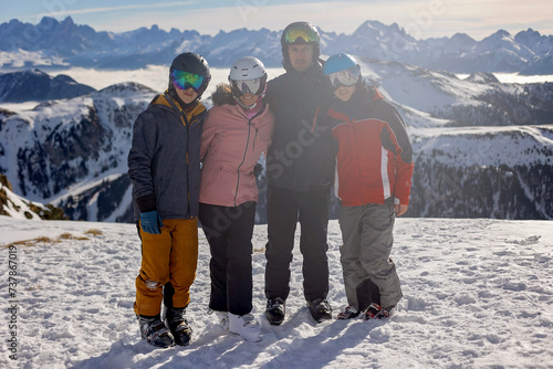 Children and adults, happy family in winter clothing at ski vacation, skiing, winter