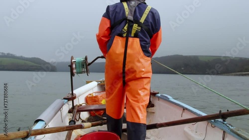 Winding in the dredge from the punt alternative angle from behind