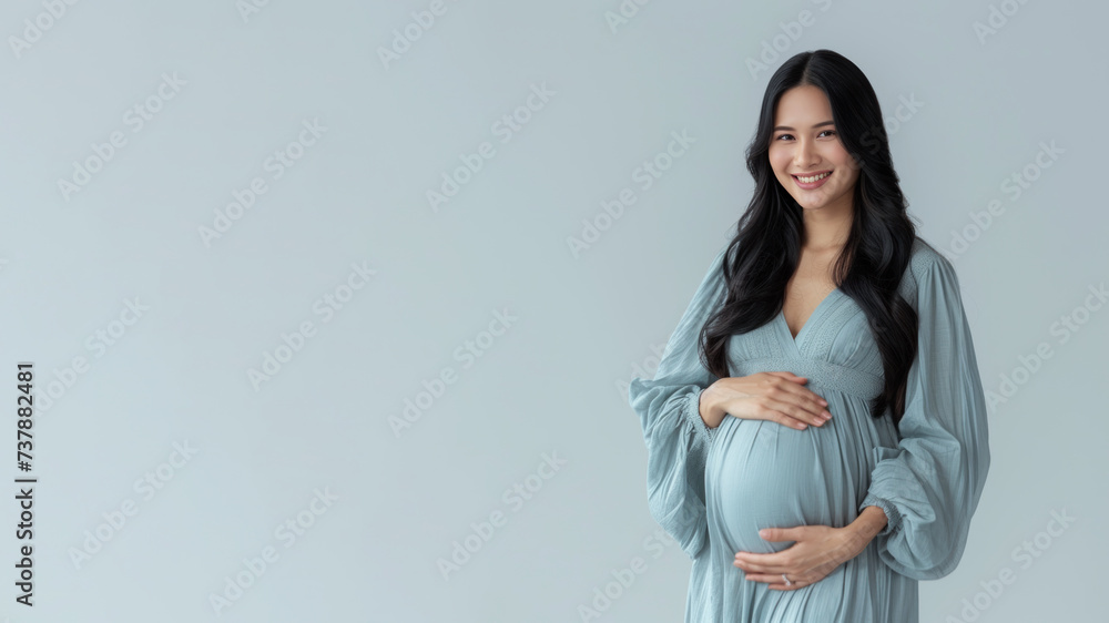 Malay pregnant woman with pregnancy belly, in soft blue clothes Malay pregnant woman with pregnancy belly, in soft blue clothes