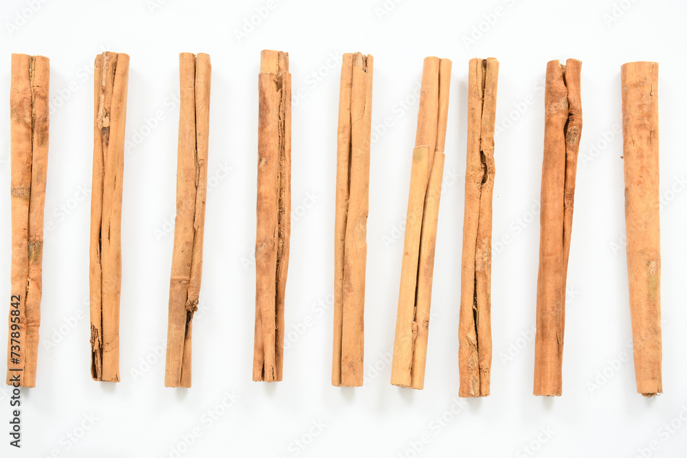 Top view of organic cinnamon sticks isolated on white. Fragrant cinnamon sticks isolated on white background. Top view of organic cinnamon sticks isolated on white. Fragrant cinnamon sticks isolated on white background.