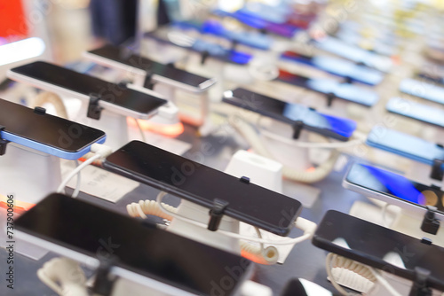 A lot of smartphone models on display at the exhibition stand of an electronics store