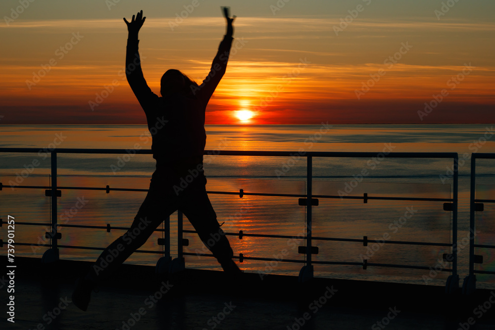 Girl silhouette in magical sunset over the Gulf of Finland, Baltic sea.