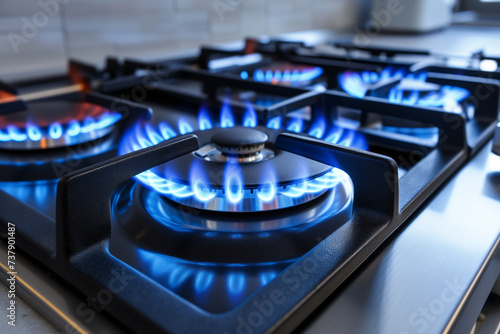 Kitchen gas stove burner with blue flame. Gas cooker with burning flames of propane gas. Global gas crisis and price rise.