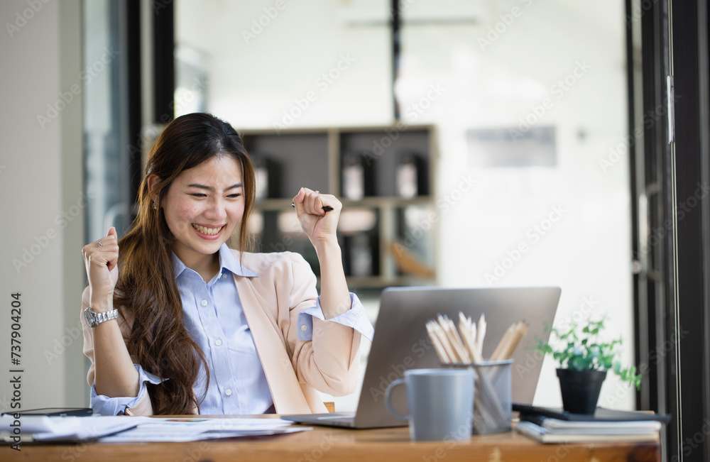 Happy asian young businesswoman excited with laptop at office workplace, Excited happy Asian woman. Happy asian young businesswoman excited with laptop at office workplace, Excited happy Asian woman.