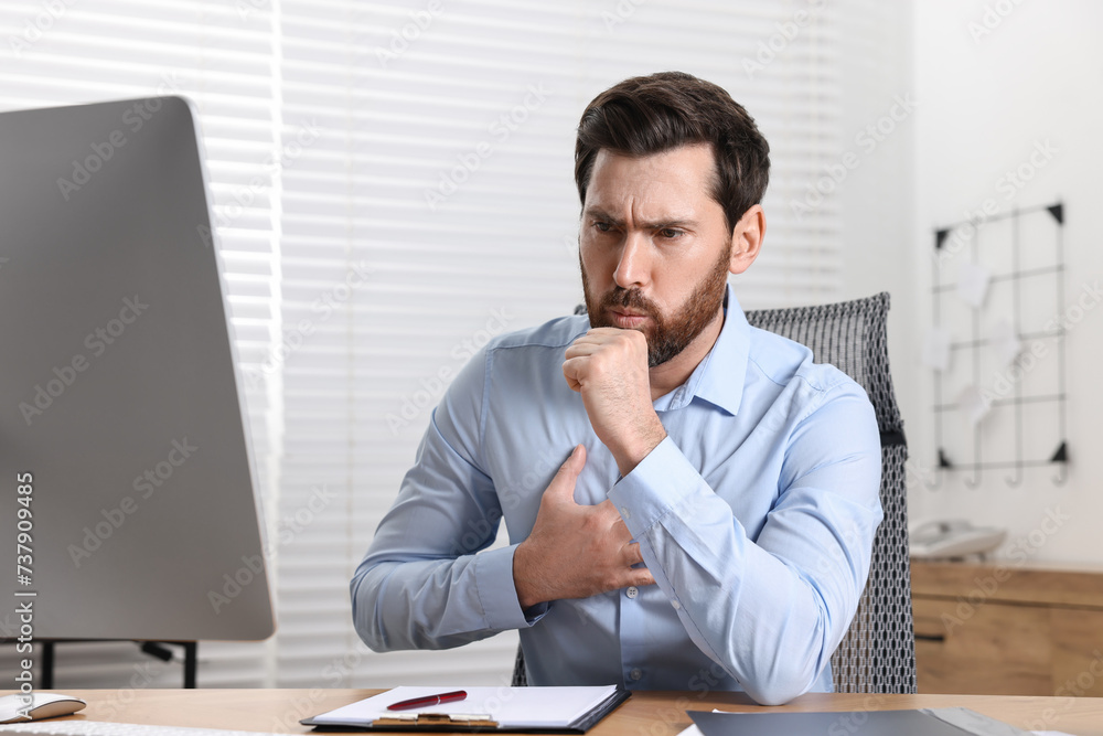 Sick man coughing at workplace in office. Cold symptoms Sick man coughing at workplace in office. Cold symptoms