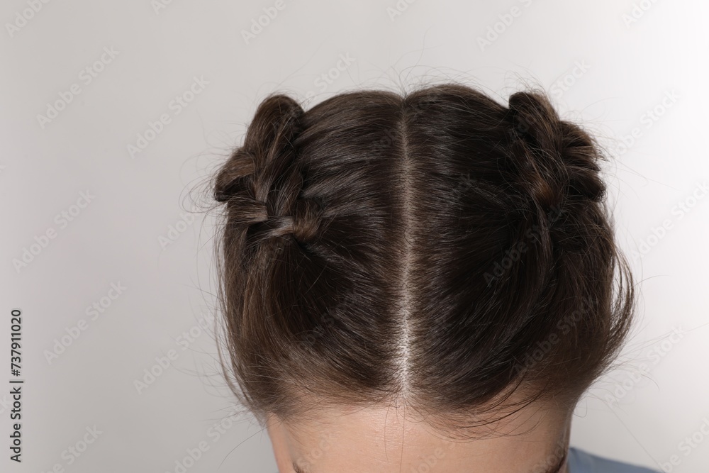 Woman with braided hair on light grey background, closeup Woman with braided hair on light grey background, closeup